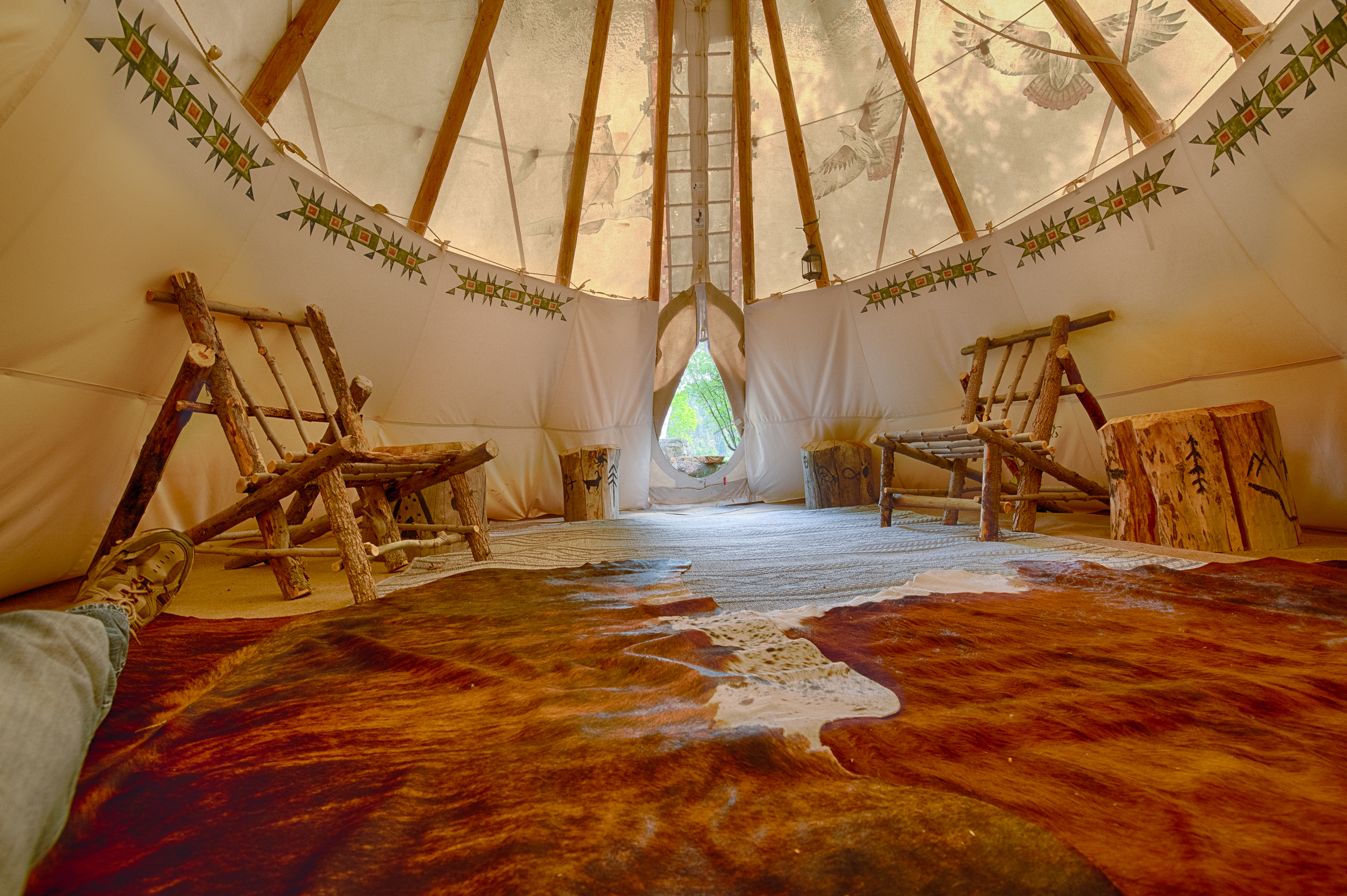 Interior of a camping tipi at Teepees by the River. Canvas teepee with Indian decorations.